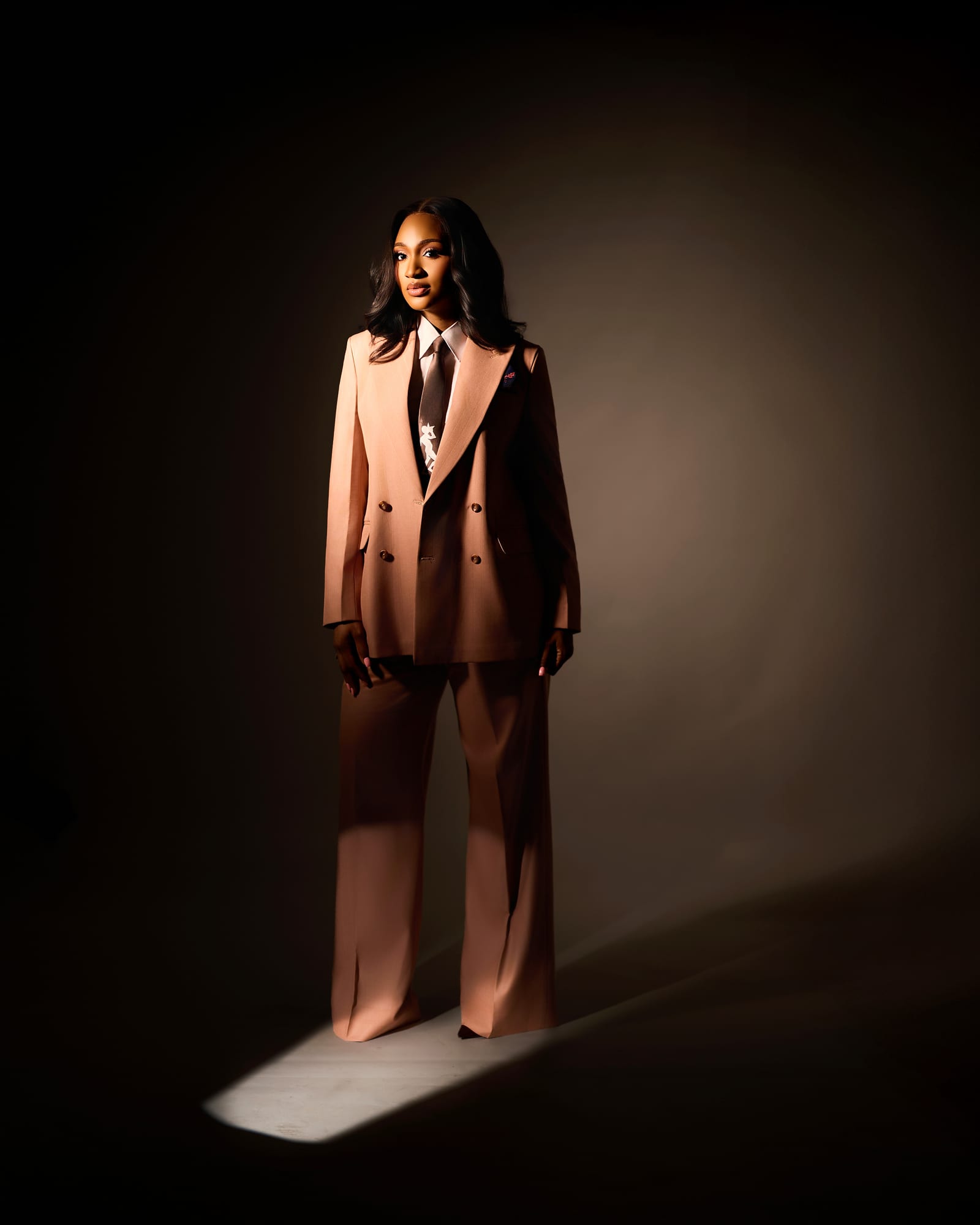 Powede Awujo in a peach tailored suit